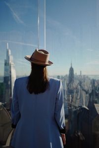 Side view of woman standing against sky