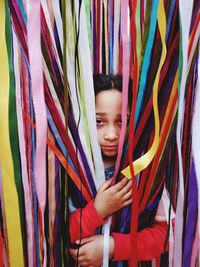 Portrait of girl holding multi colored ribbons