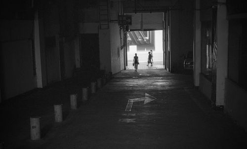 Silhouette woman entering underground parking lot