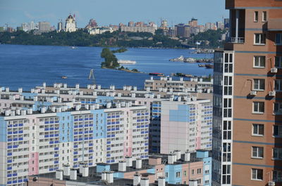 High angle view of buildings by sea against sky