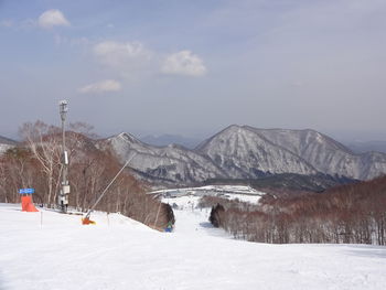 Scenic view of snow covered mountains against sky