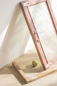 High angle view of window and tennis ball on floor