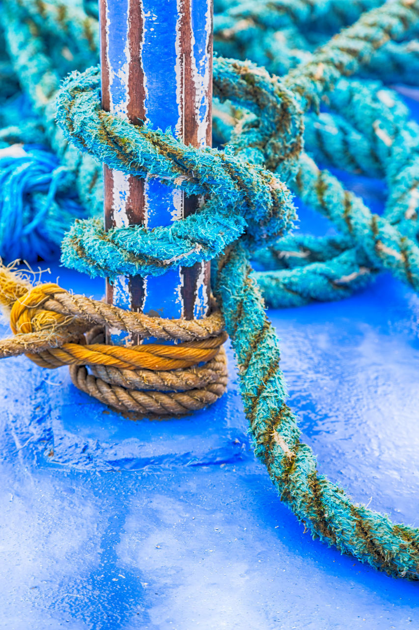 CLOSE-UP OF ROPE TIED UP BOAT