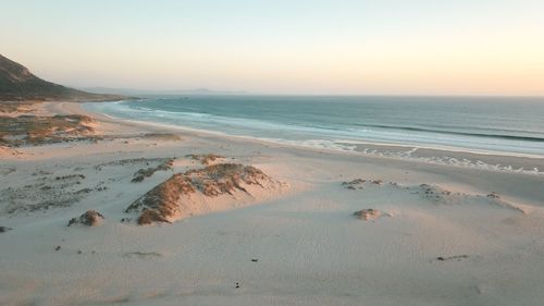 Scenic view of beach against clear sky