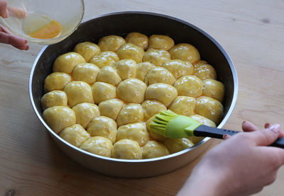 Cropped hand of person preparing food