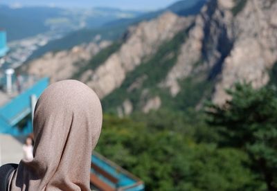 Close-up of woman in hijab against mountains