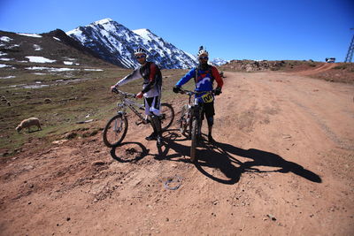 Full length of two men on mountain road