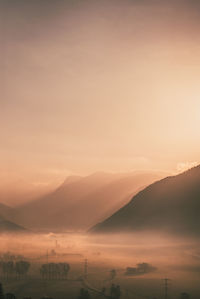 Scenic view of mountains against sky during sunrise