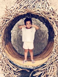 Rear view of woman standing in tunnel
