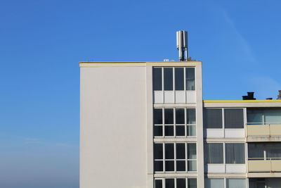 Low angle view of building against clear blue sky