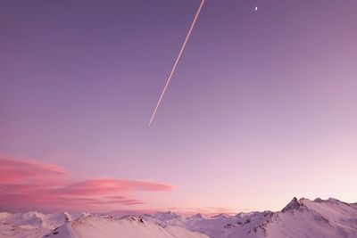 Scenic view of snowcapped mountains against sky during sunset