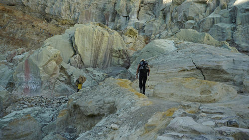 Rear view of man standing on rock