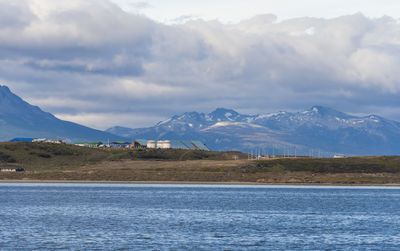 Scenic view of sea and mountains against sky