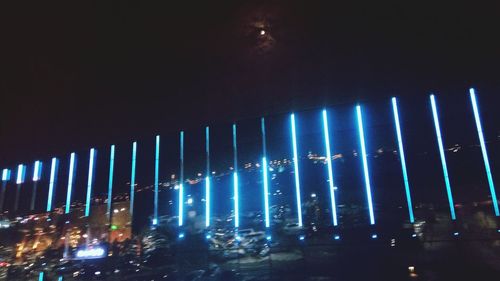 Low angle view of illuminated building against sky at night