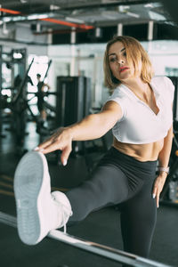 An active girl does stretching exercises after a workout in the gym. sports, fitness, healthy body