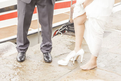 Low section of woman standing on tiled floor