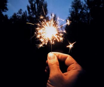 Person hand holding firework display