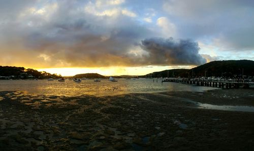 Scenic view of beach against dramatic sky