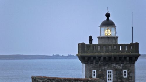 Lighthouse by sea against clear sky in france 