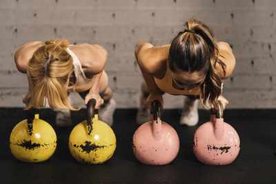 Couple of female athletes in harmony during a training session in a gym hall. effort and improvement