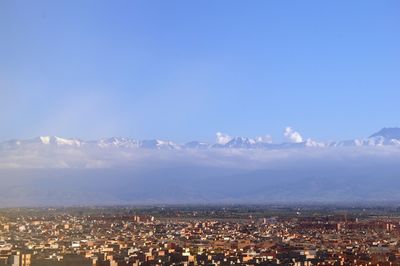 High angle view of cityscape against mountains and sky