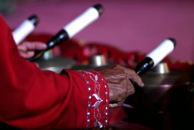 Cropped hand of person playing traditional music instrument
