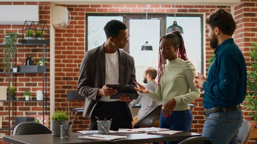 Portrait of smiling business colleagues working in cafe