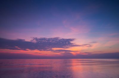 Scenic view of sea against romantic sky at sunset