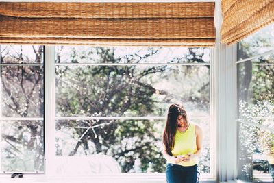 Woman standing by window