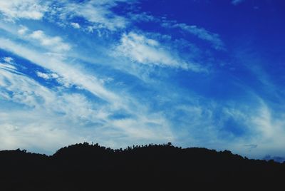 Scenic view of mountains against cloudy sky