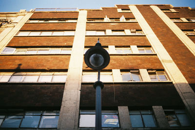 Low angle view of street light against building