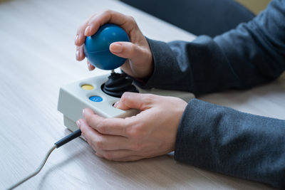 High angle view of man using mobile phone on table