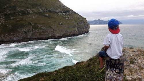 Rear view of boy looking at sea