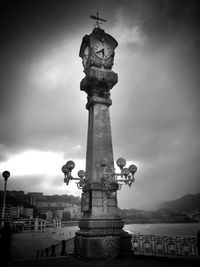 Low angle view of monument against cloudy sky