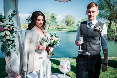 Young couple standing against blue sky