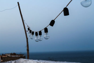 Lighting equipment on beach against clear sky