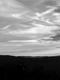 Scenic view of field against cloudy sky