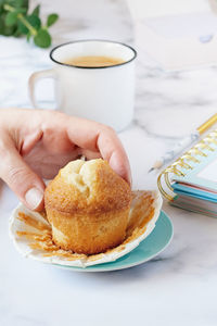 Woman's hand grabbing a homemade muffin.