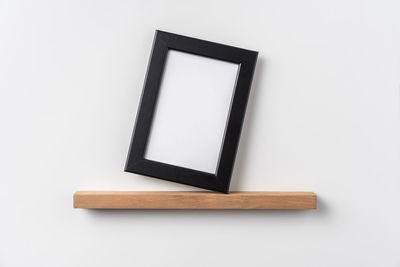 Close-up of empty table against white background