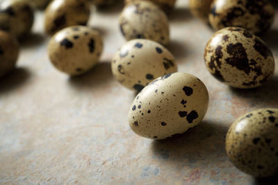 Quail eggs on a stone table.