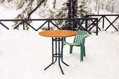 Empty chairs on snow covered field