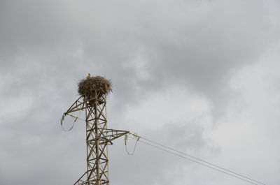 Low angle view of communications tower against sky