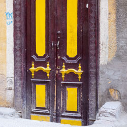 Yellow closed door of old building