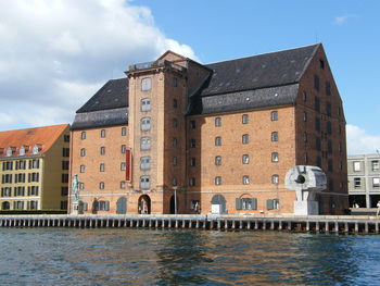 View of buildings against cloudy sky