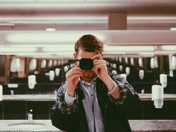 Portrait of man photographing