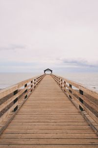 Pier over sea against sky