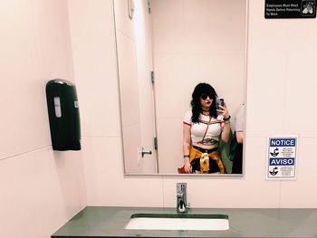 Portrait of woman standing in bathroom