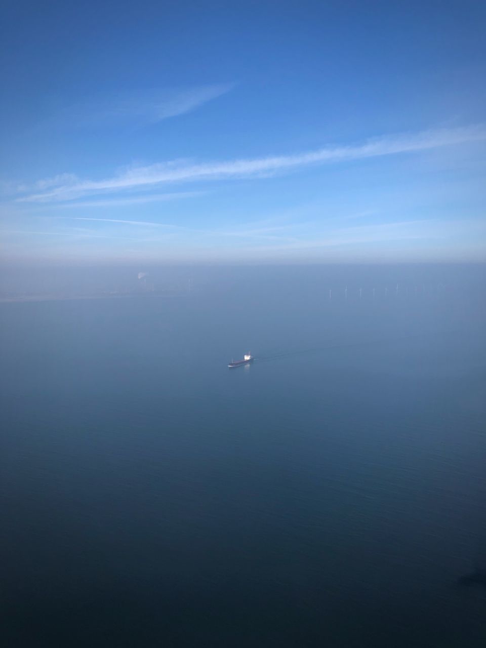 AERIAL VIEW OF SEA AGAINST BLUE SKY