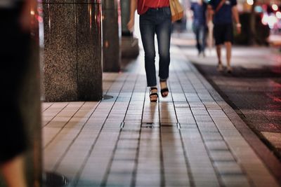 Low section of women walking on floor