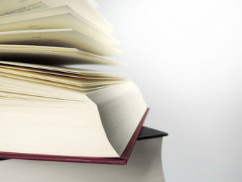 Close-up of book on table against white background